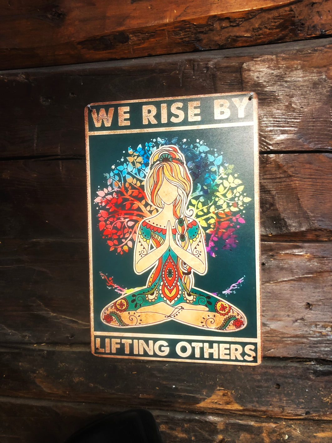 Tin sign - We rise by lifting others